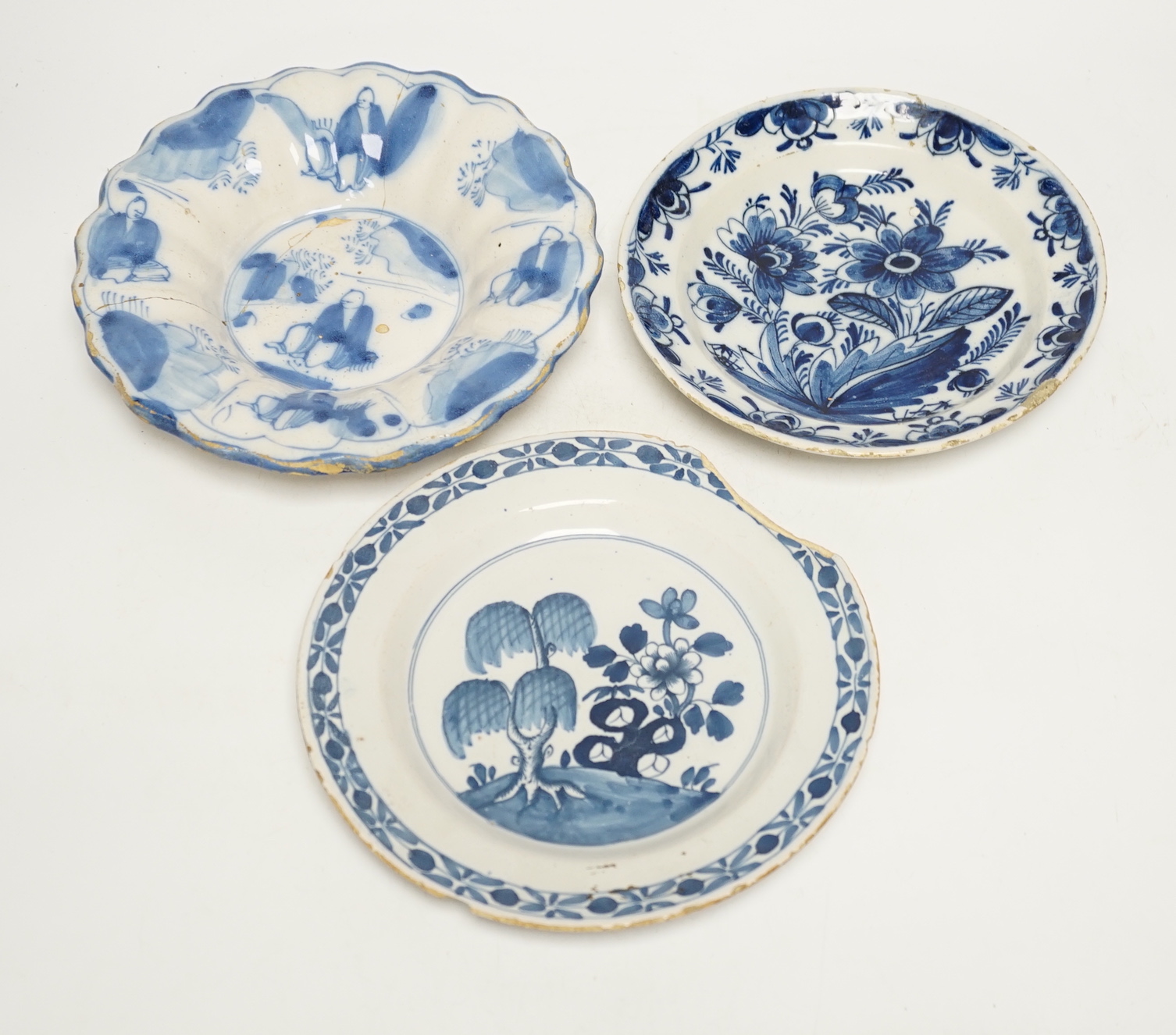 A Delft lobed blue and white dish, 1680-1700 and two 18th century Delft plates, largest 21cm in diameter